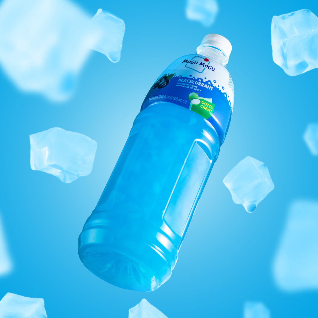 Mogu Mogu Blackcurrant 1L bottle surrounded by nata de coco